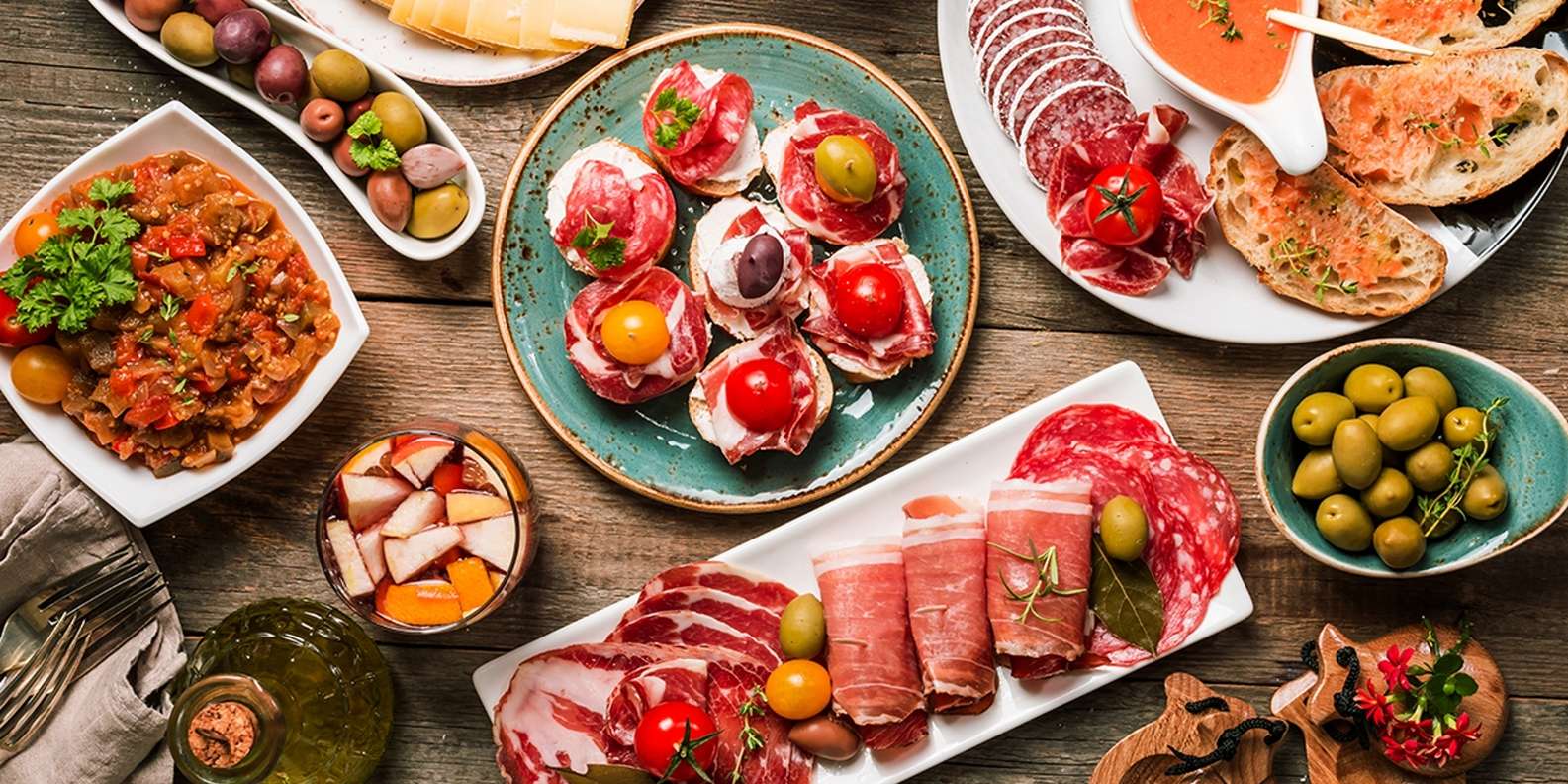 Lots of different plates of meat, as seen on a Madrid food tour (alternative tour in Madrid).