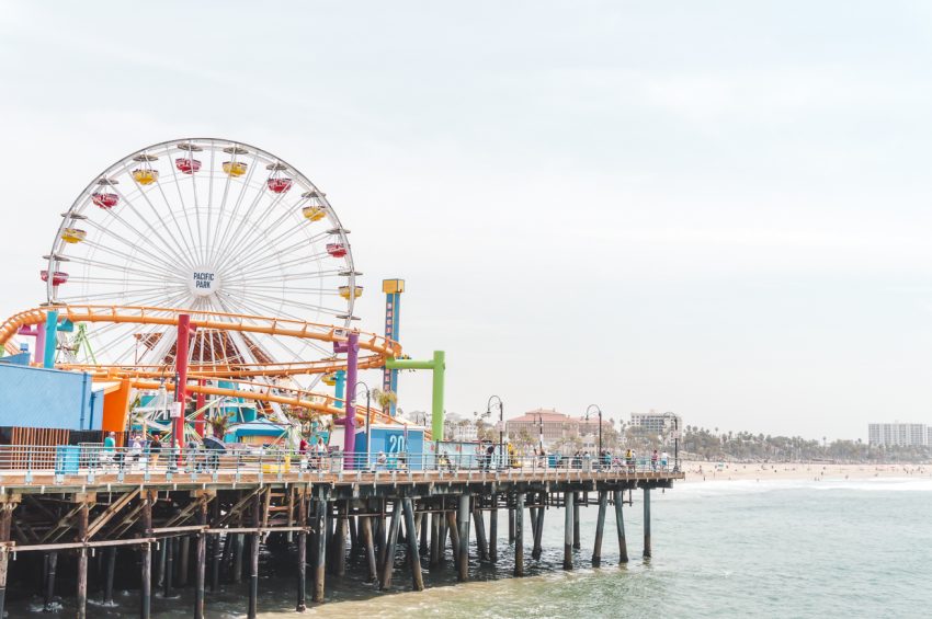 Ferris wheel and roller coaster at Santa Monica Pier in Los Angeles, California (another one of the best places for solo vacations USA).