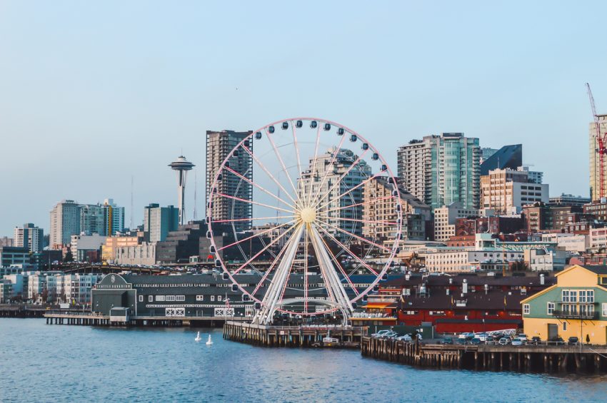 City views from Bainbridge Island ferry in Seattle, Washington, which captures both the waterfront Ferris wheel and the iconic Space Needle.