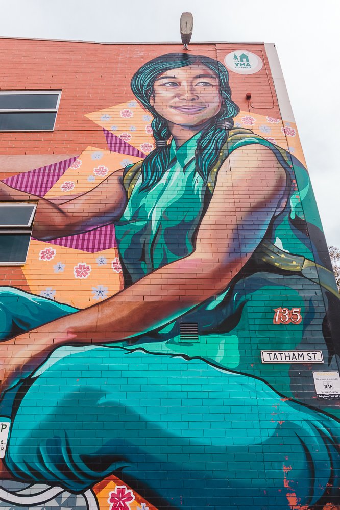 Street art of a woman outside the YHA Adelaide, a budget-friendly accommodation for your weekend in Adelaide.