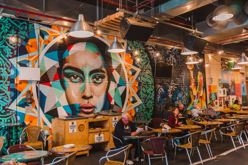 Colourful street art and tables and chairs inside Adelaide Central Market
