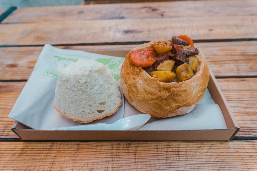 Dont be afraid to dine solo when travelling in Europe alone. Here is a bread bowl overflowing with goulash in Budapest, Hungary.