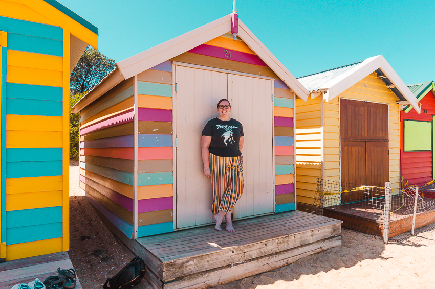 Standing in front of the colourful Brighton Bathing Boxes in Melbourne.