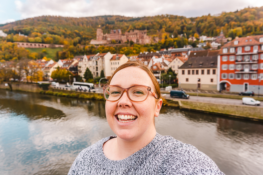 Smiling with the castle backdrop in Heidelberg, Germany