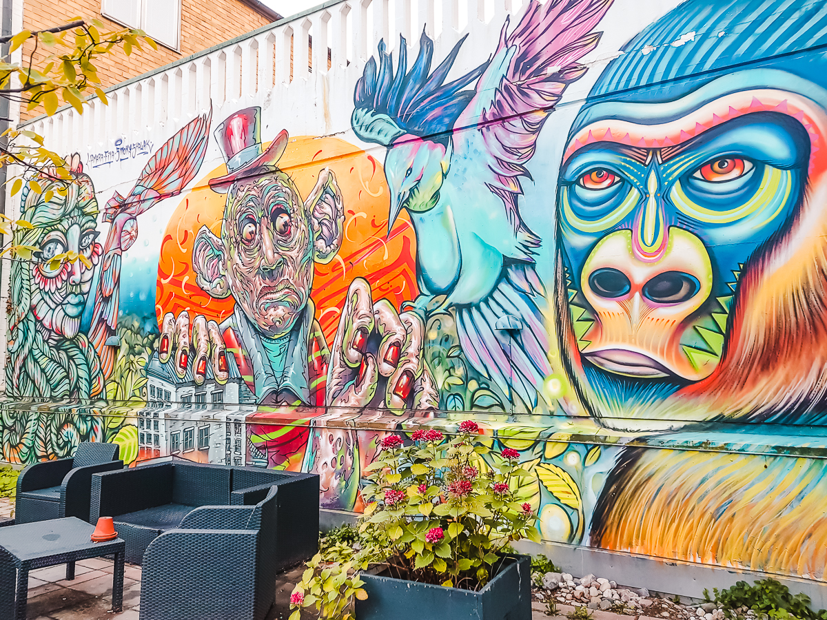 Colourful street art featuring a magician, bird and gorilla in the courtyard at STF Malmo, Sweden