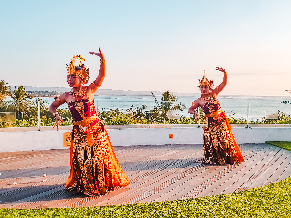 Two dancers in traditional Balinese dress performing on a deck at Beachwalk Shopping Centre in Kuta, Bali